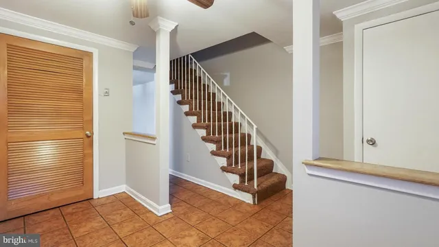 a view of a hallway with windows and stairs