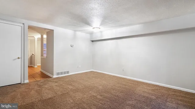 an empty room with closet and a chandelier fan
