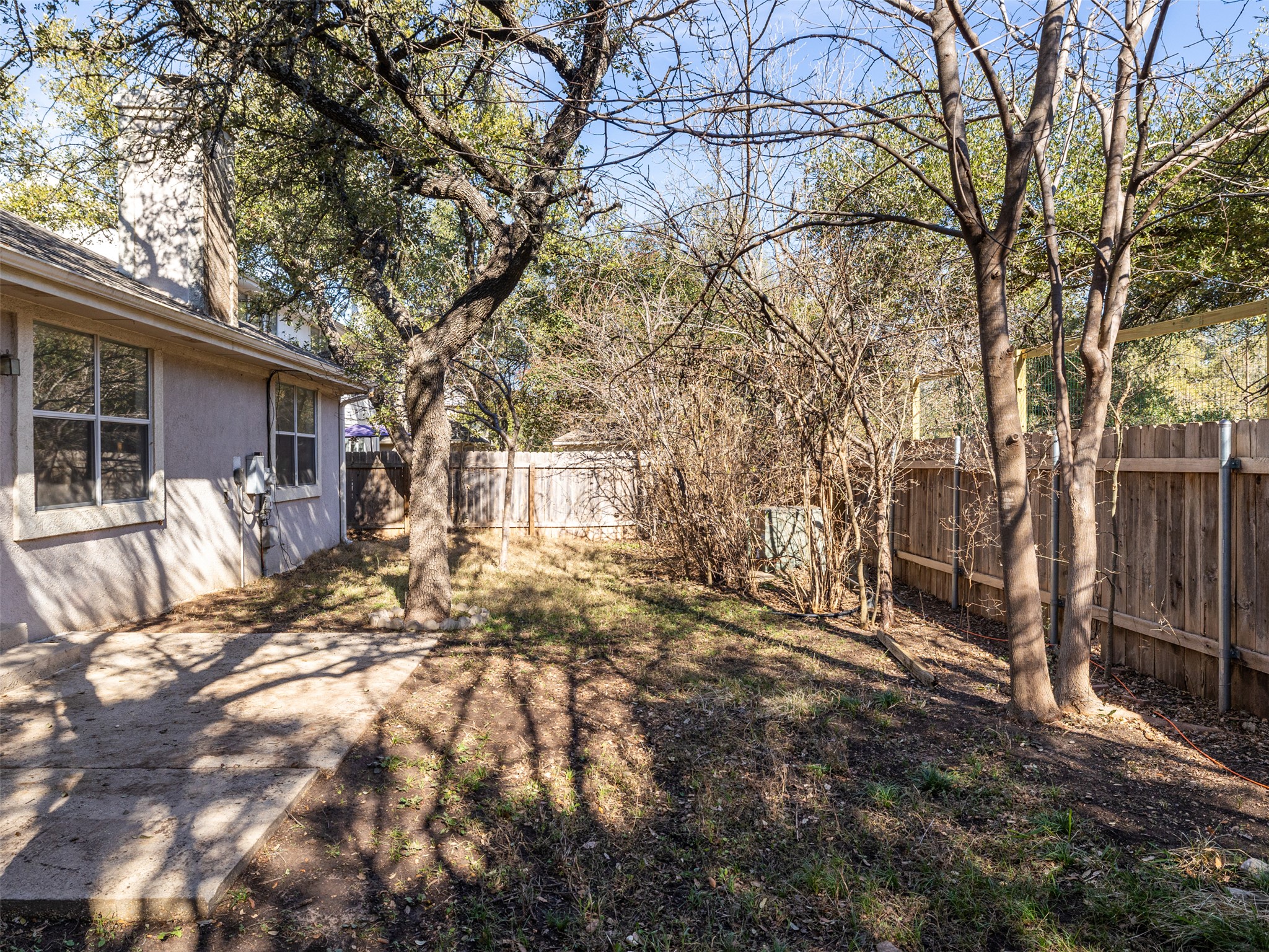 8537 Foxhound Trail Austin, TX 78729 - Photo 23 of 26 Fenced backyard with a patio