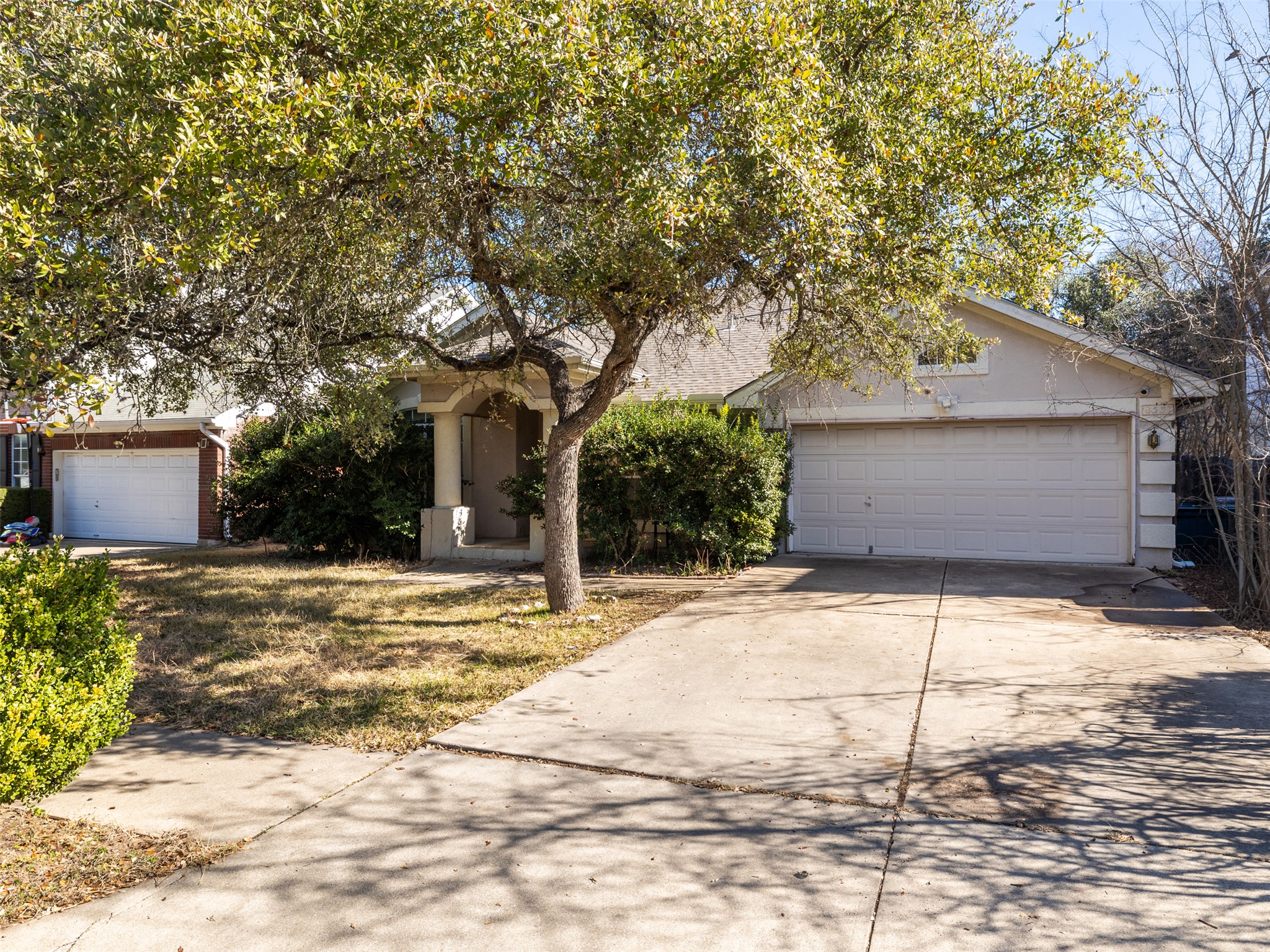 8537 Foxhound Trail Austin, TX 78729 - Photo 3 of 26 View of front of house with concrete driveway and an attached garage