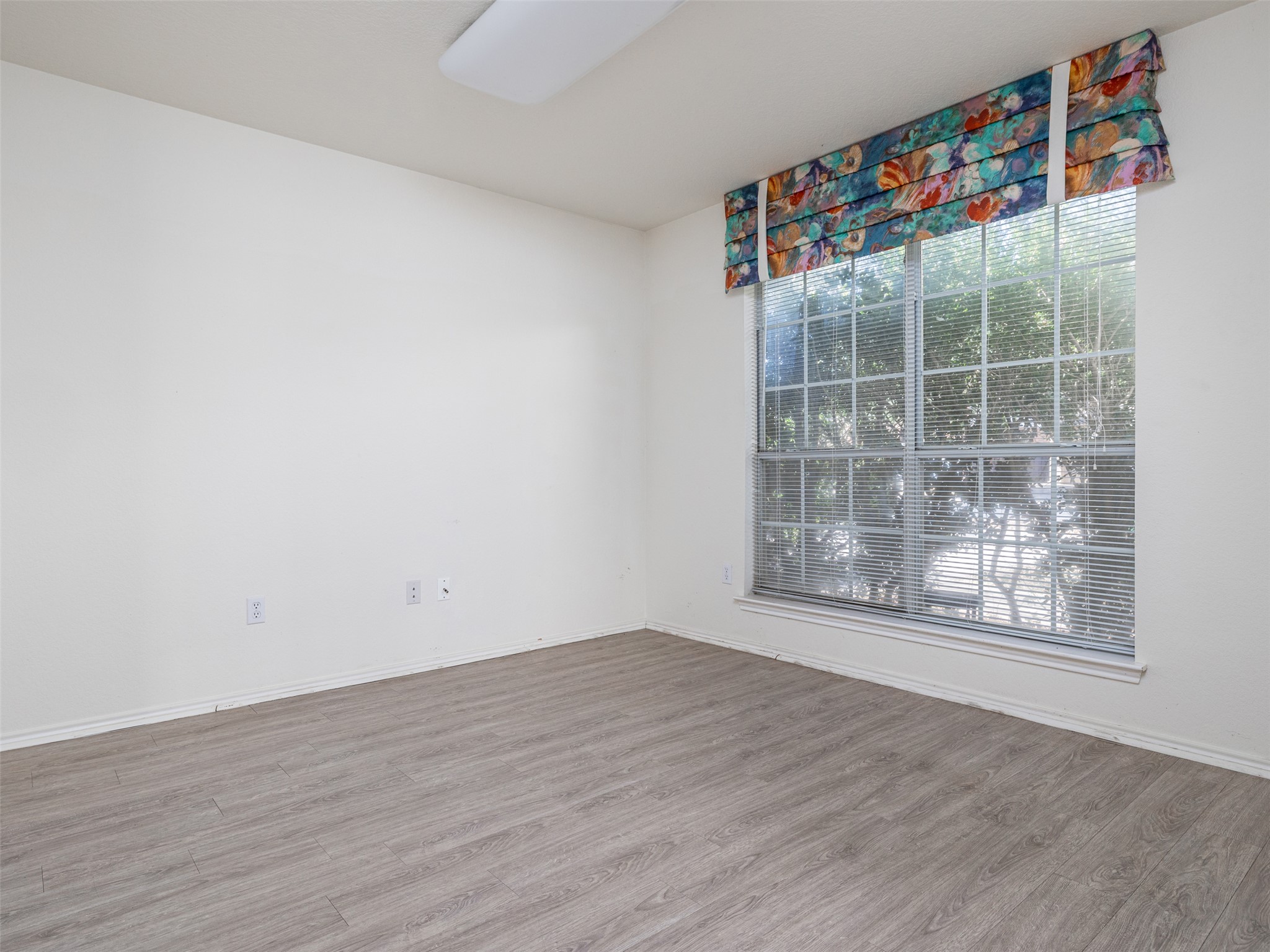 8537 Foxhound Trail Austin, TX 78729 - Photo 6 of 26 Unfurnished room featuring wood finished floors and baseboards