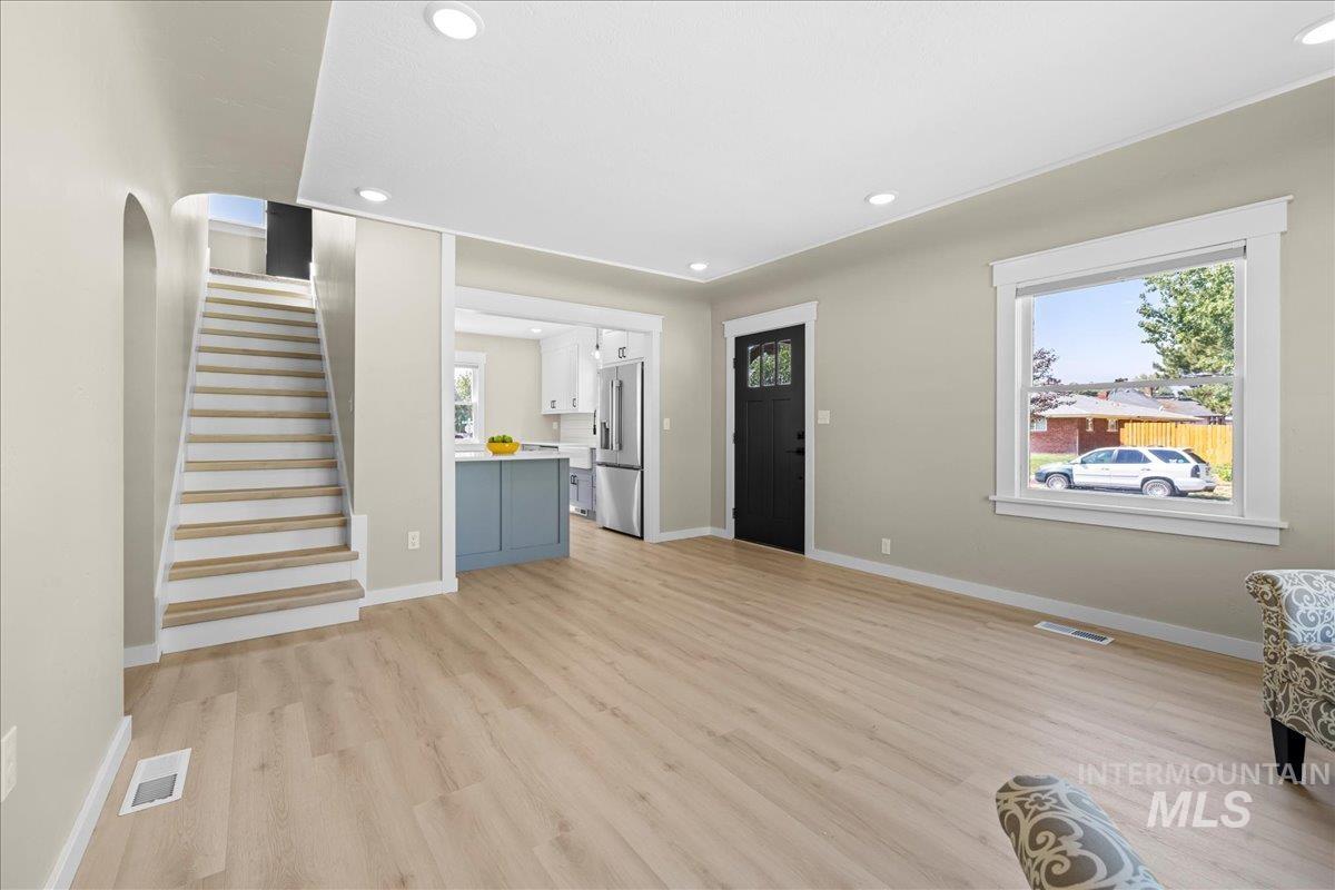 914 West 3rd Street Weiser, ID 83672 - Photo 12 of 49 Unfurnished living room with recessed lighting, light wood-style flooring, and stairway