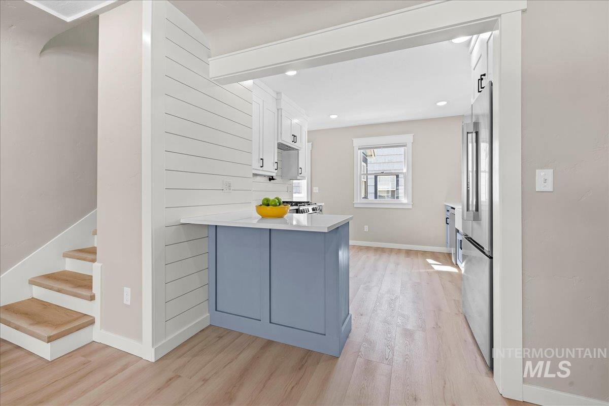 914 West 3rd Street Weiser, ID 83672 - Photo 13 of 49 Kitchen with white cabinets, a peninsula, light wood finished floors, and high end refrigerator