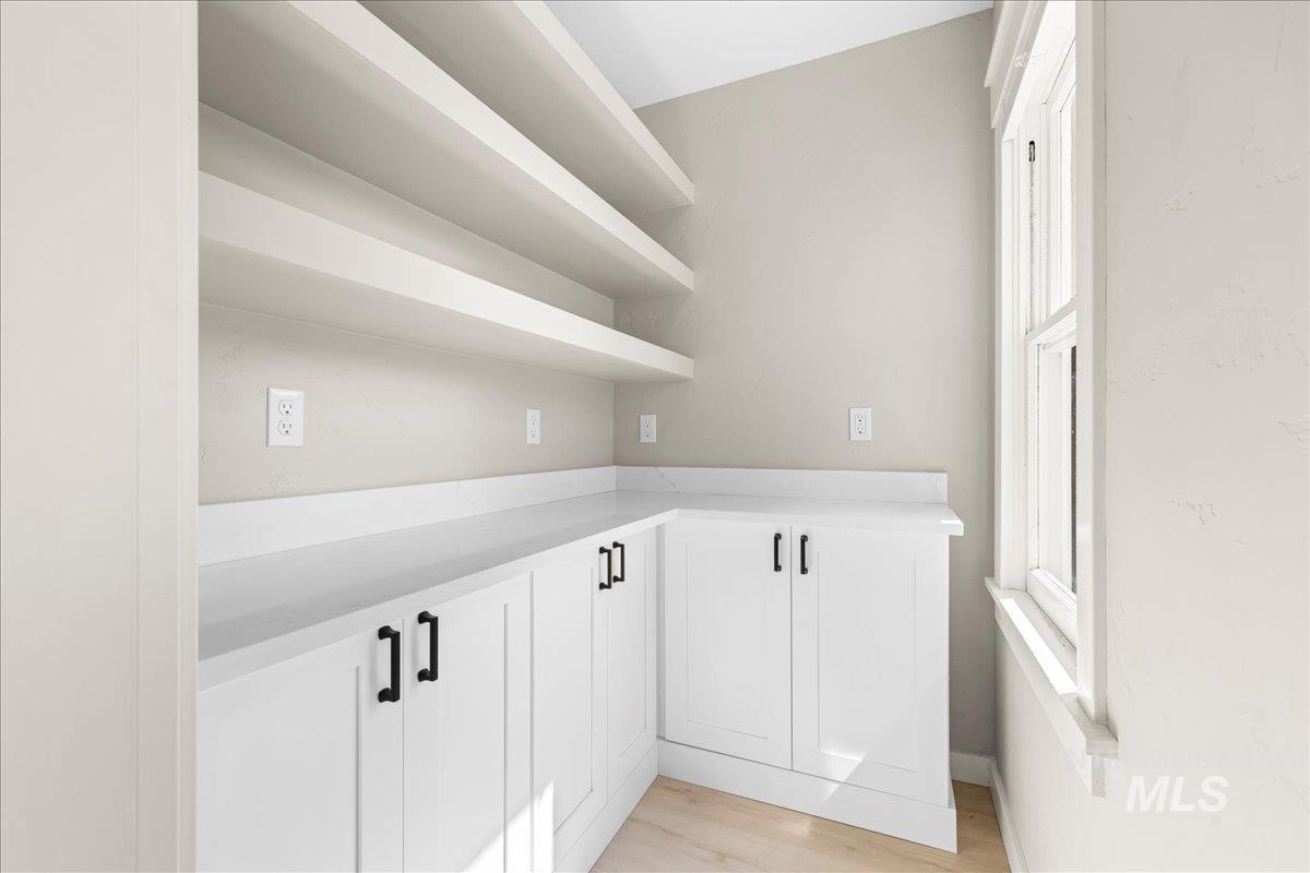 914 West 3rd Street Weiser, ID 83672 - Photo 17 of 49 Kitchen featuring white cabinetry, light wood finished floors, and open shelves