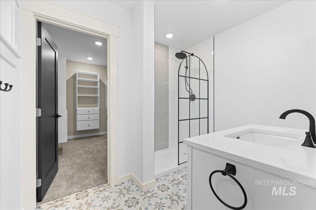 914 West 3rd Street Weiser, ID 83672 - Photo 28 of 49 Bathroom with walk in shower, a walk in closet, vanity, and recessed lighting