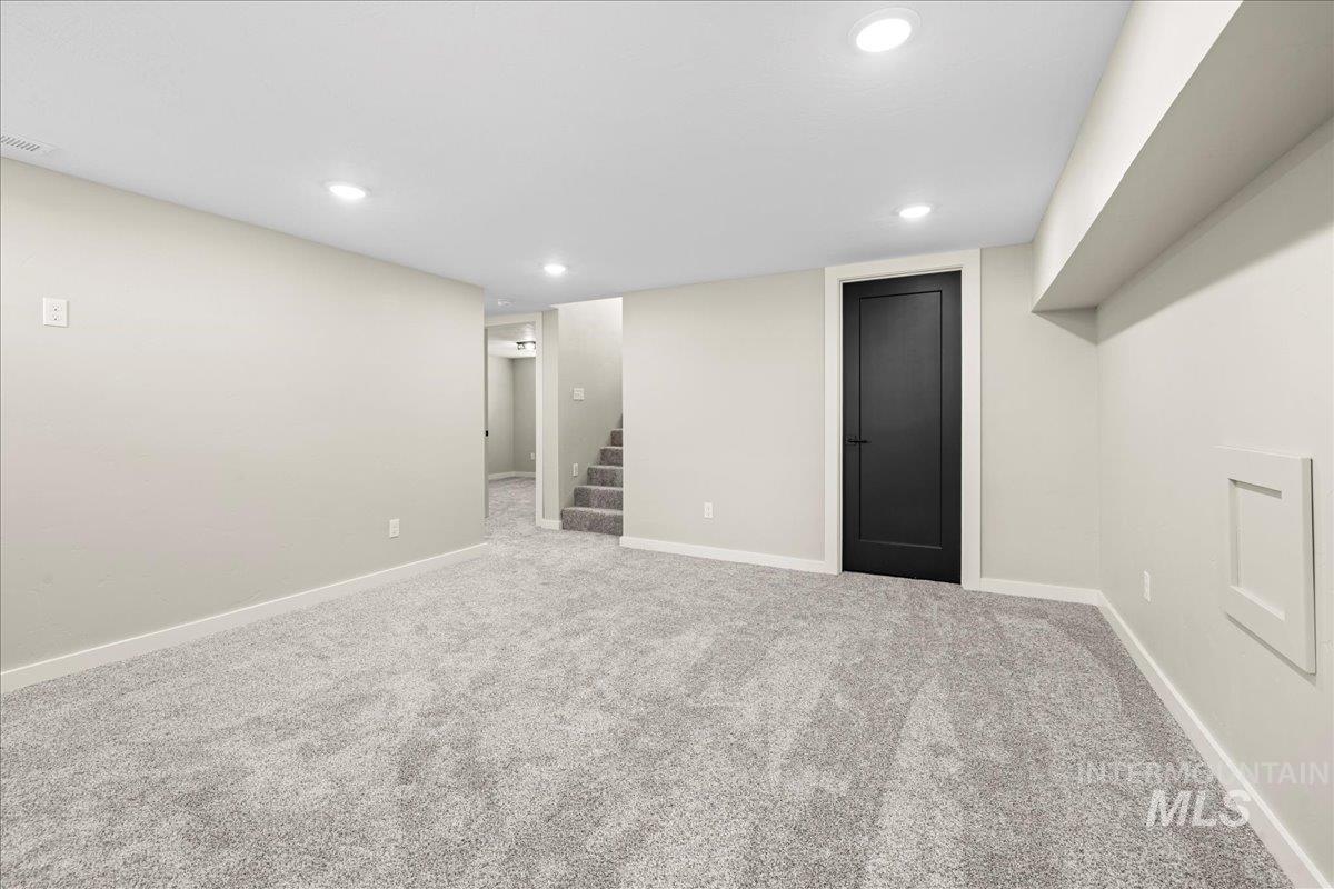 914 West 3rd Street Weiser, ID 83672 - Photo 31 of 49 Finished below grade area with light colored carpet, stairs, and recessed lighting