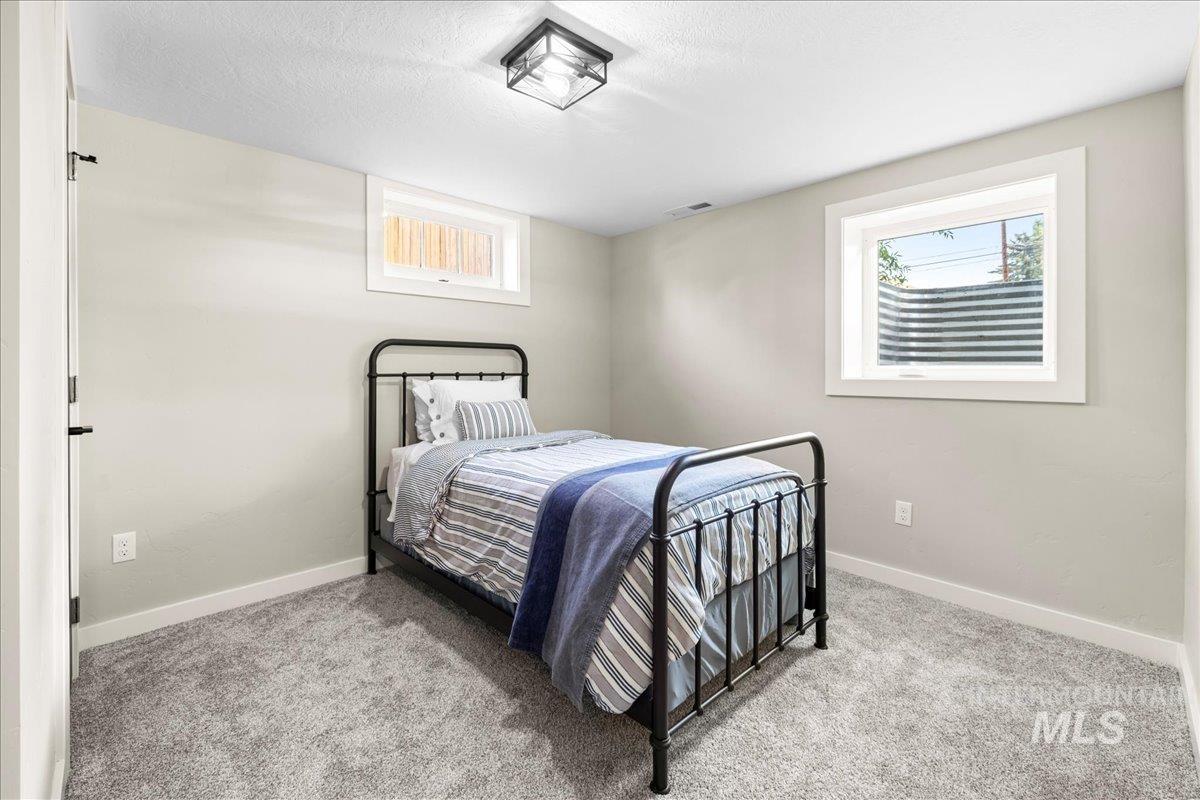 914 West 3rd Street Weiser, ID 83672 - Photo 32 of 49 Bedroom with light carpet and a textured ceiling