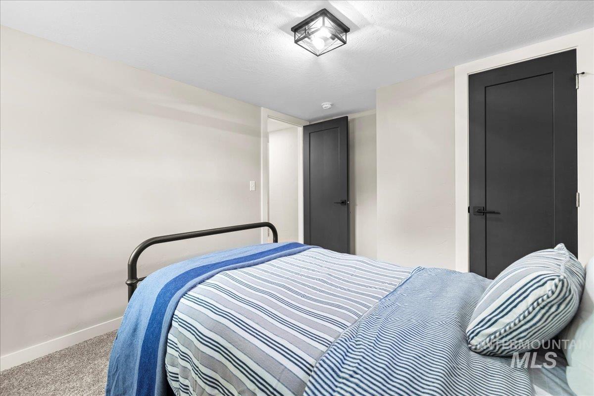 914 West 3rd Street Weiser, ID 83672 - Photo 33 of 49 Bedroom with a textured ceiling and carpet floors