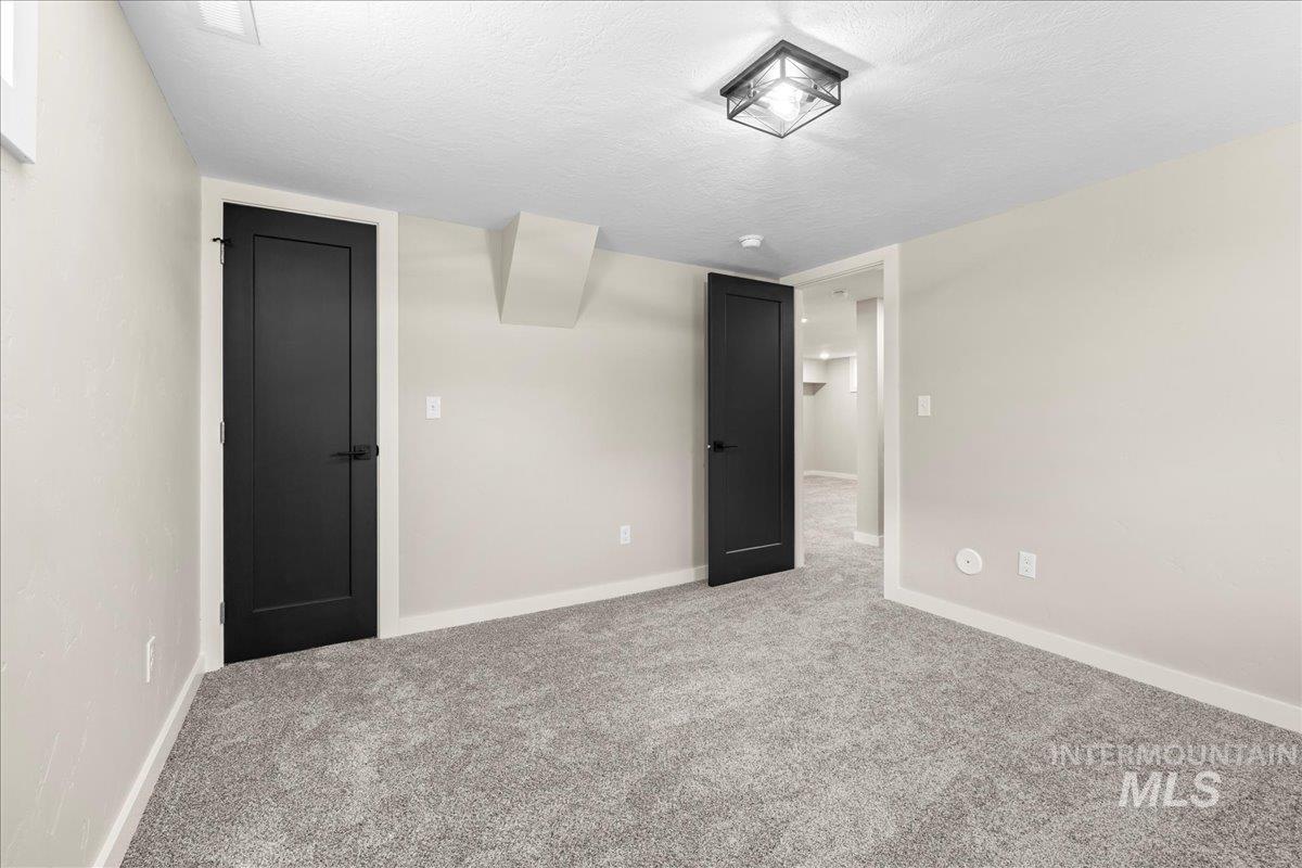 914 West 3rd Street Weiser, ID 83672 - Photo 34 of 49 Unfurnished bedroom featuring a textured ceiling and carpet