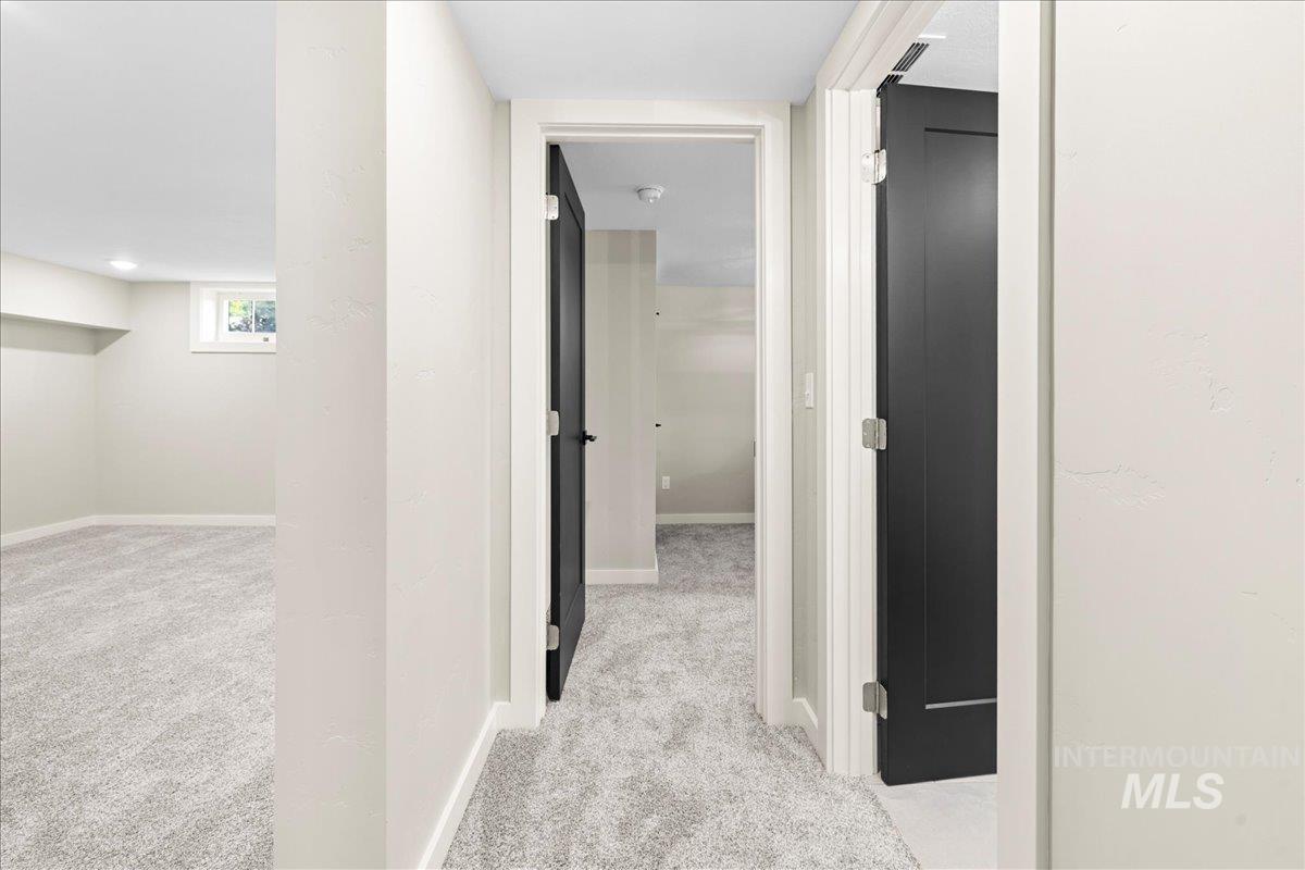 914 West 3rd Street Weiser, ID 83672 - Photo 37 of 49 Corridor with light carpet and baseboards
