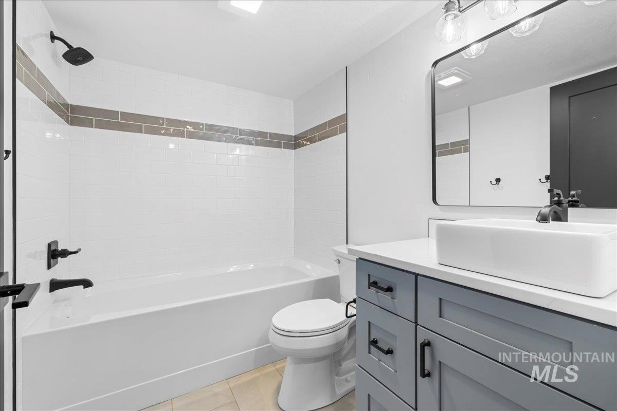 914 West 3rd Street Weiser, ID 83672 - Photo 38 of 49 Full bathroom featuring shower / bathtub combination, vanity, and light tile patterned floors
