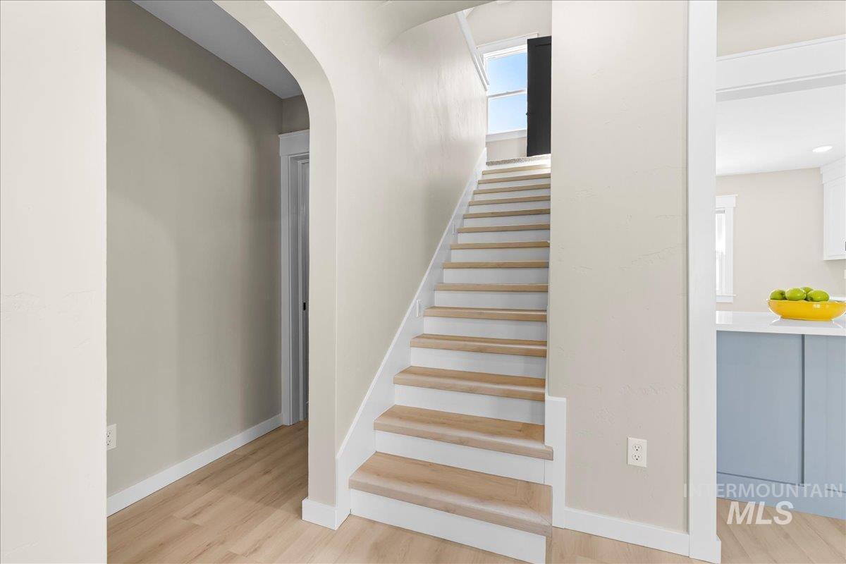 914 West 3rd Street Weiser, ID 83672 - Photo 39 of 49 Stairway featuring wood finished floors and arched walkways