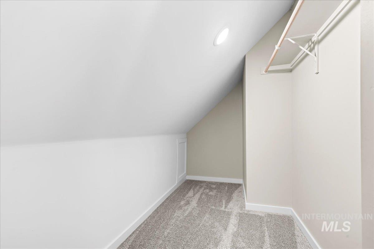 914 West 3rd Street Weiser, ID 83672 - Photo 42 of 49 Spacious closet featuring light carpet and vaulted ceiling