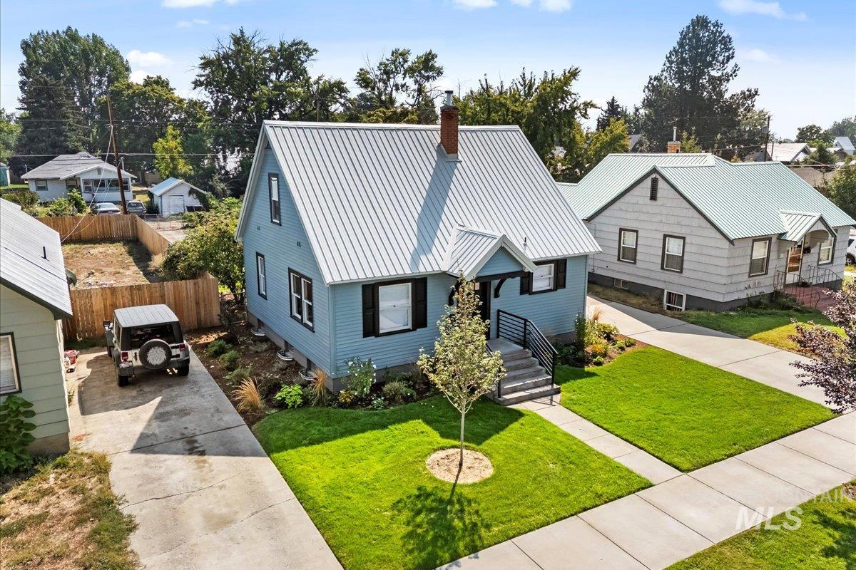 914 West 3rd Street Weiser, ID 83672 - Photo 48 of 49 View of front of property with a metal roof, concrete driveway, and a chimney