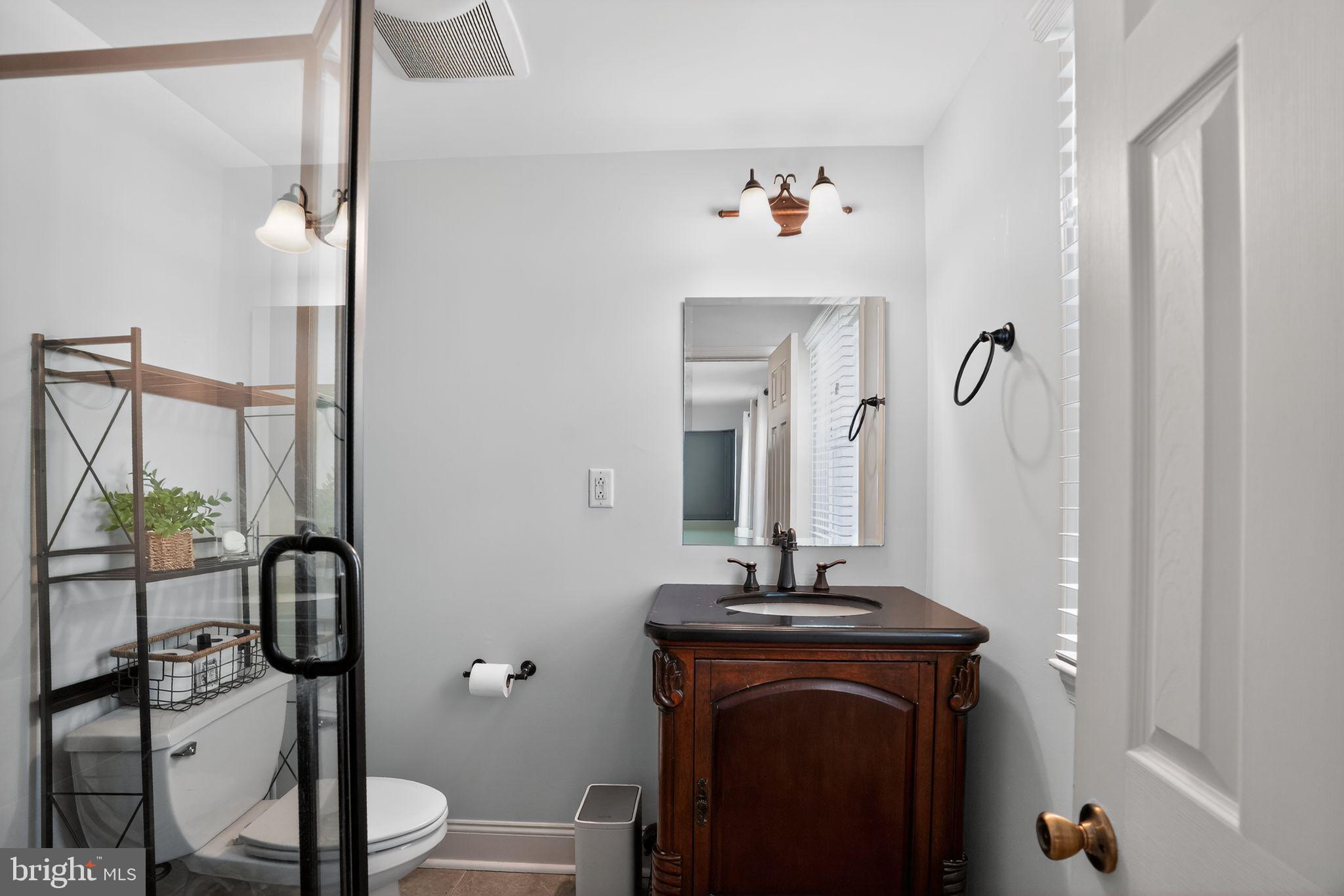 962 Edwards Drive Springfield, PA 19064 - Photo 22 of 32 a bathroom with a sink vanity mirror and toilet