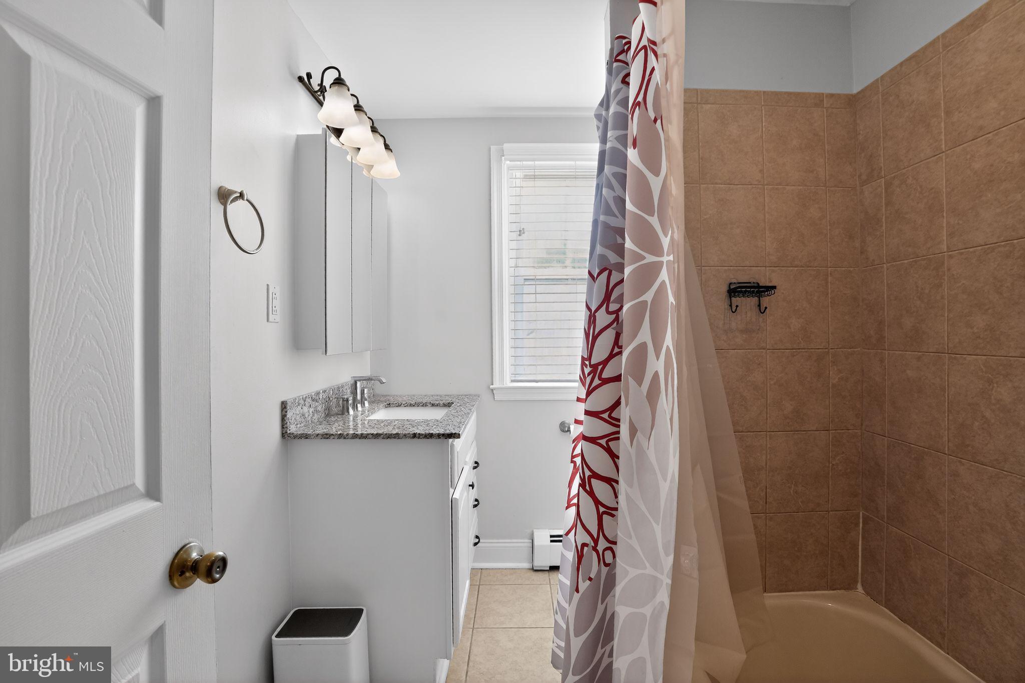 962 Edwards Drive Springfield, PA 19064 - Photo 26 of 32 a bathroom with a bathtub and shower