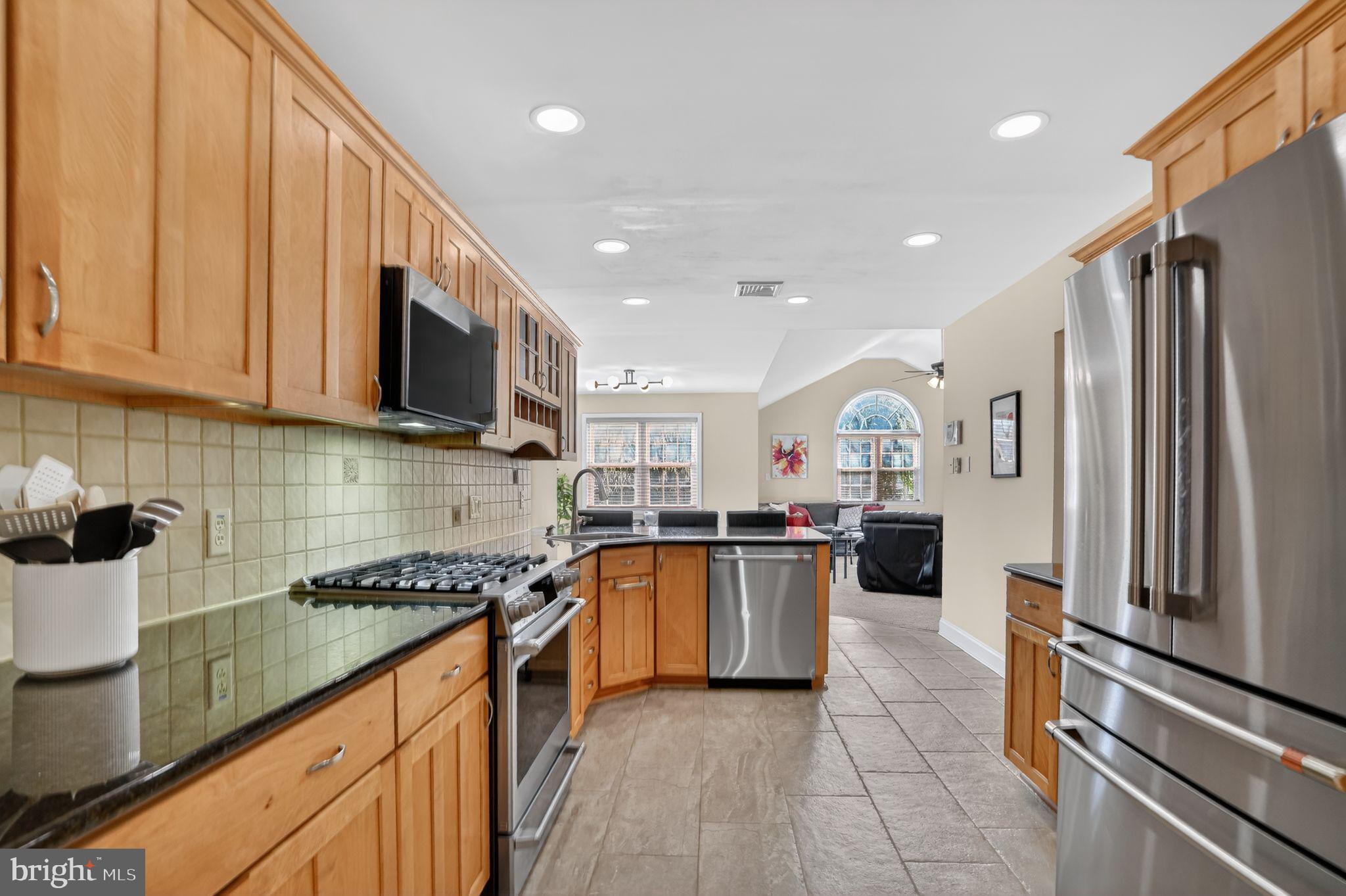 962 Edwards Drive Springfield, PA 19064 - Photo 7 of 32 a kitchen with stainless steel appliances granite countertop a stove top oven a sink a refrigerator and cabinets