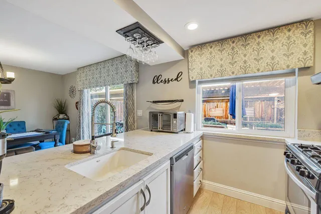a kitchen with stainless steel appliances a sink and a refrigerator