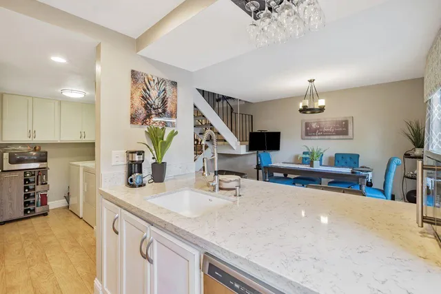a bathroom with a granite countertop sink a mirror and a bathtub