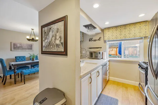 a kitchen with a stove and a white refrigerator