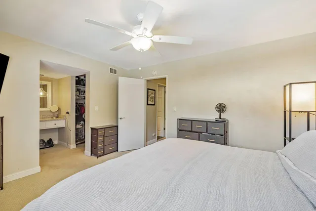 a bedroom with a bed mirror and a window