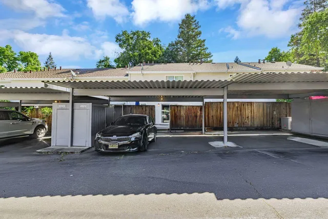 a living room with furniture a rug and a chandelier
