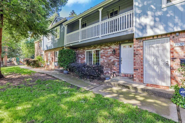 a view of a house with a patio and backyard