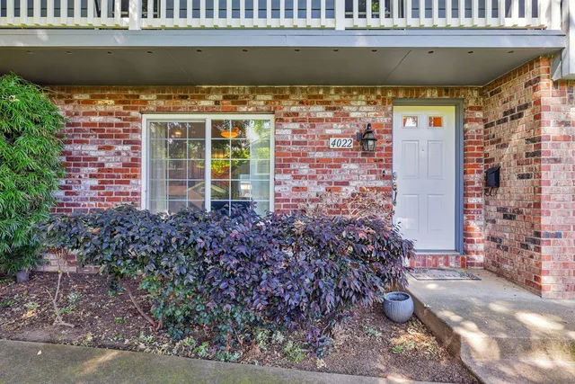 a view of a patio with table and chairs and potted plants
