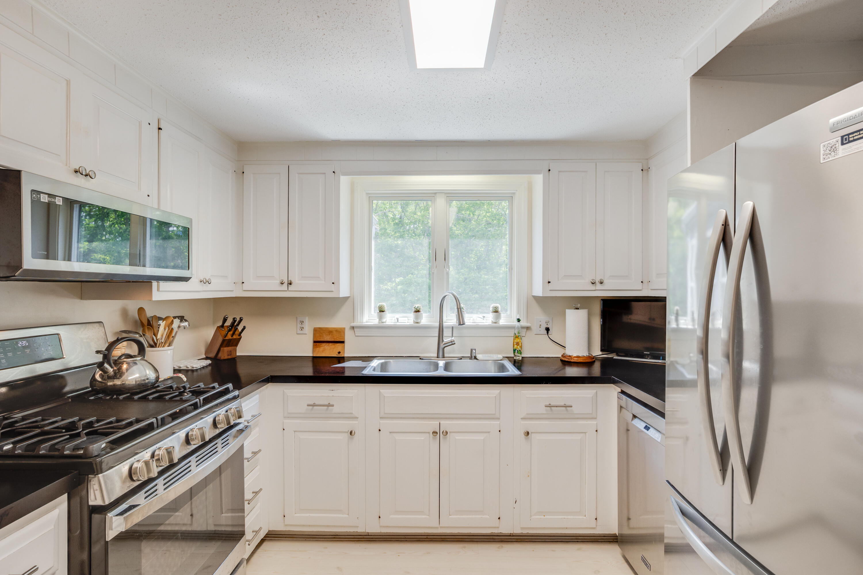240 Braggs Lane Barnstable, MA 02630 - Photo 14 of 54 a kitchen with stainless steel appliances granite countertop a sink stove and refrigerator