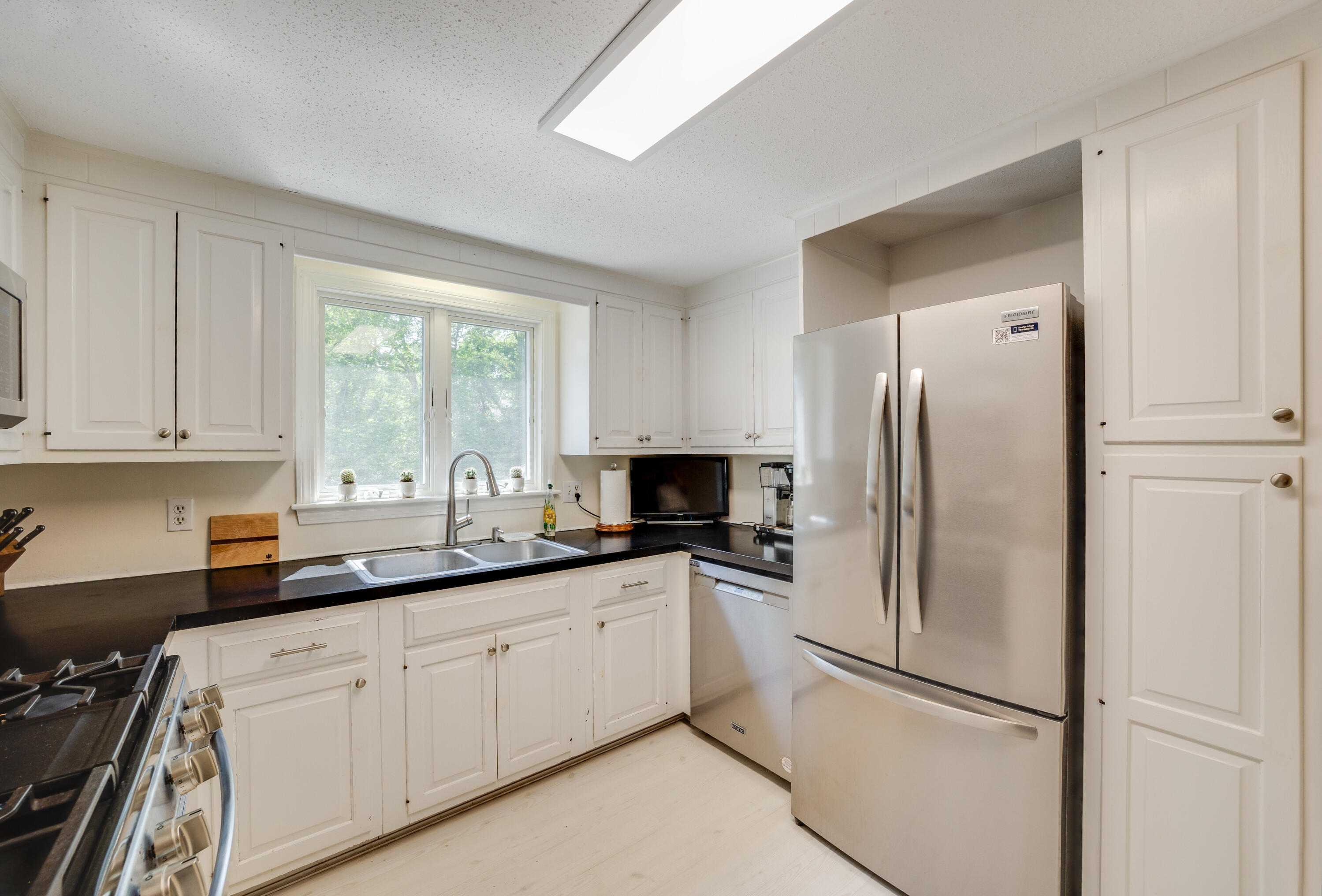 240 Braggs Lane Barnstable, MA 02630 - Photo 17 of 54 a kitchen with stainless steel appliances granite countertop a refrigerator sink and cabinets