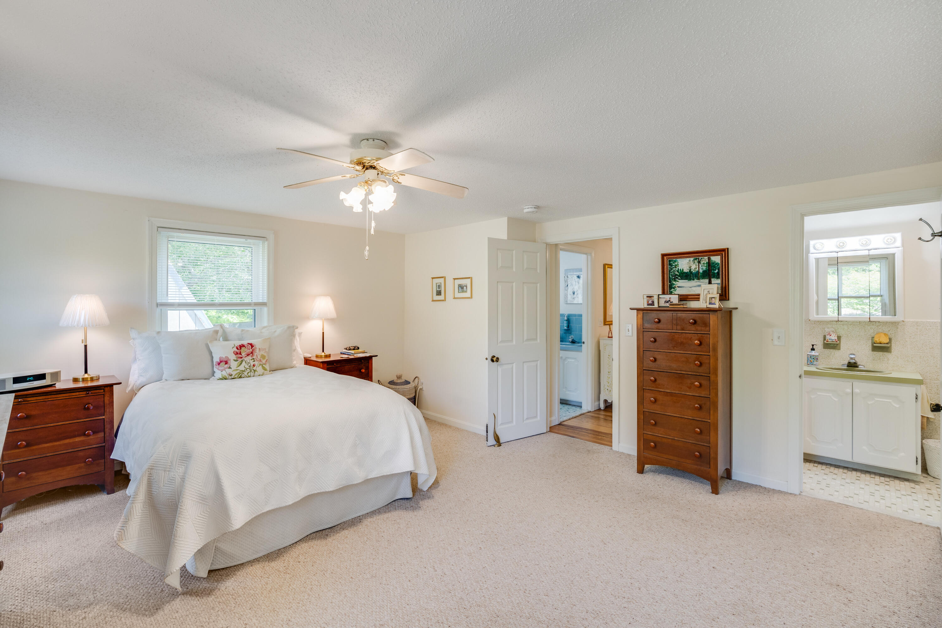 240 Braggs Lane Barnstable, MA 02630 - Photo 25 of 54 a bedroom with a bed and a chandelier