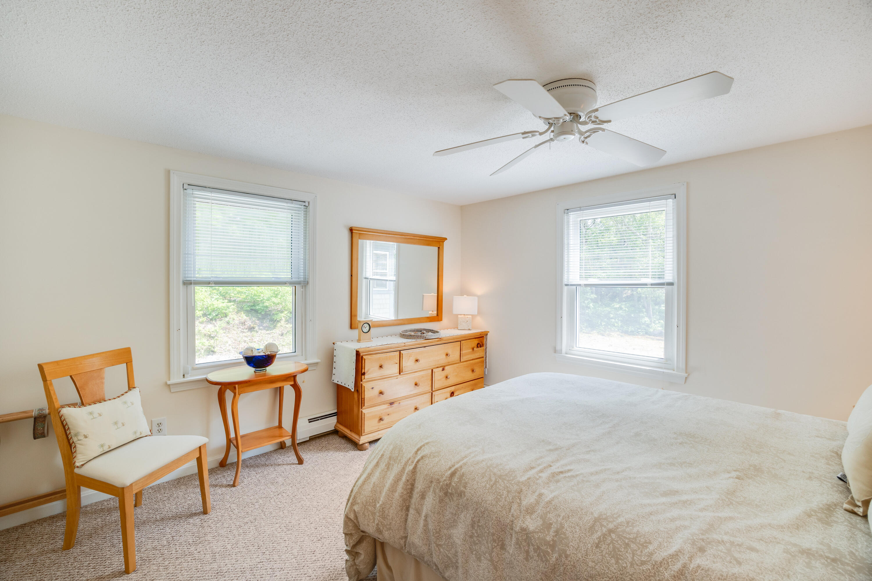 240 Braggs Lane Barnstable, MA 02630 - Photo 28 of 54 a spacious bedroom with a bed and a chair
