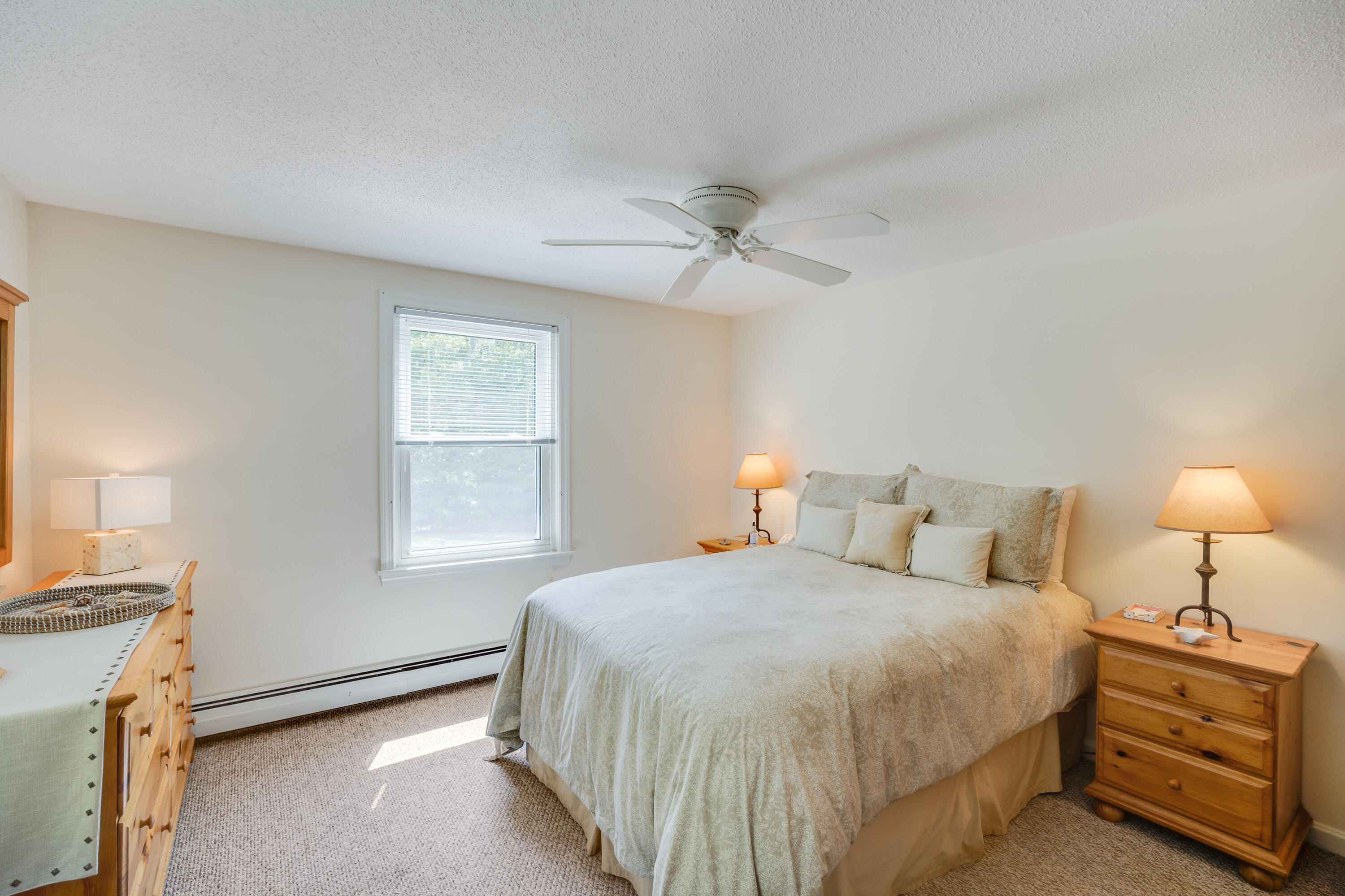 240 Braggs Lane Barnstable, MA 02630 - Photo 29 of 54 a bedroom with a bed and a chandelier