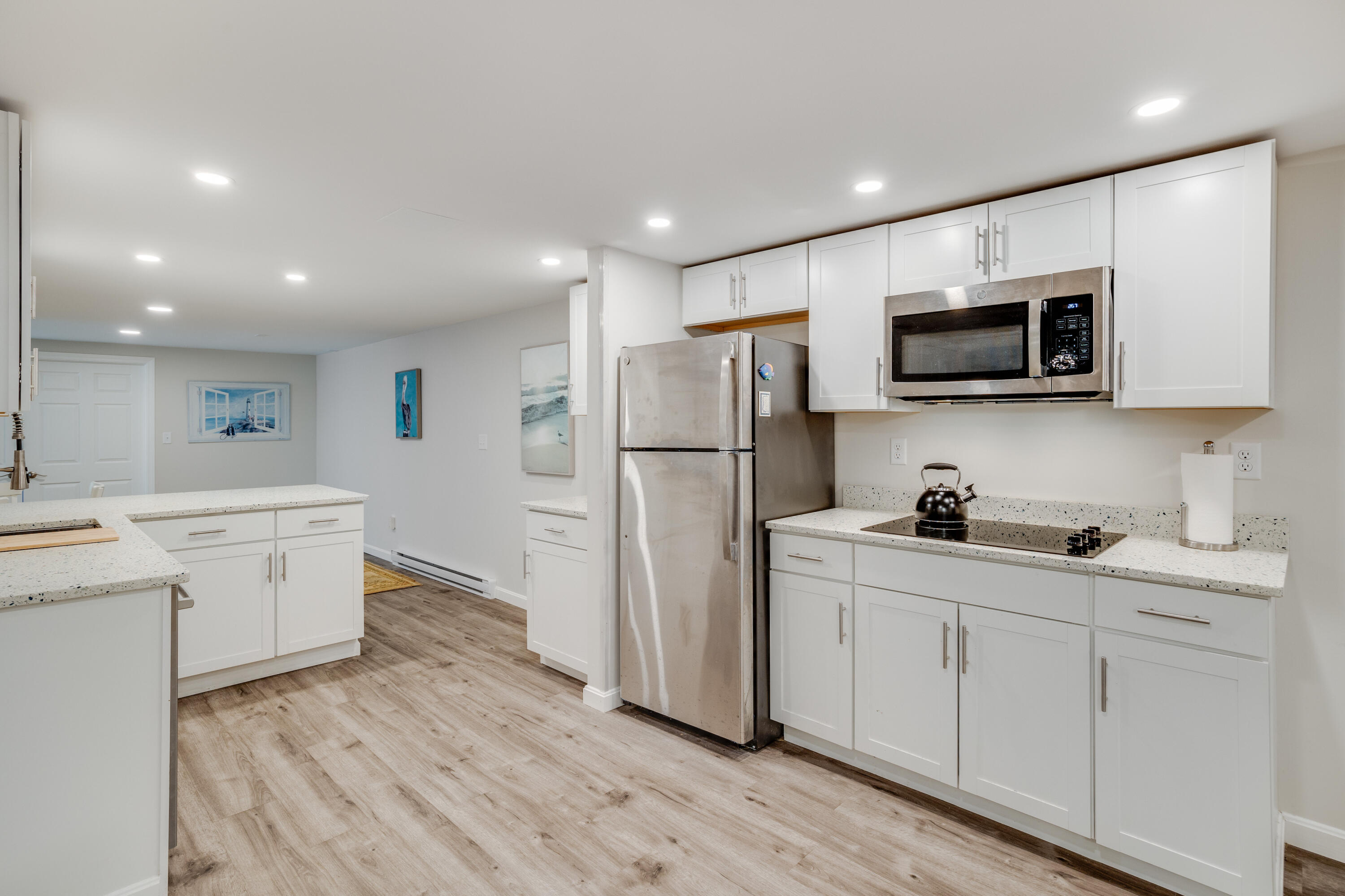240 Braggs Lane Barnstable, MA 02630 - Photo 39 of 54 a kitchen with white cabinets and stainless steel appliances