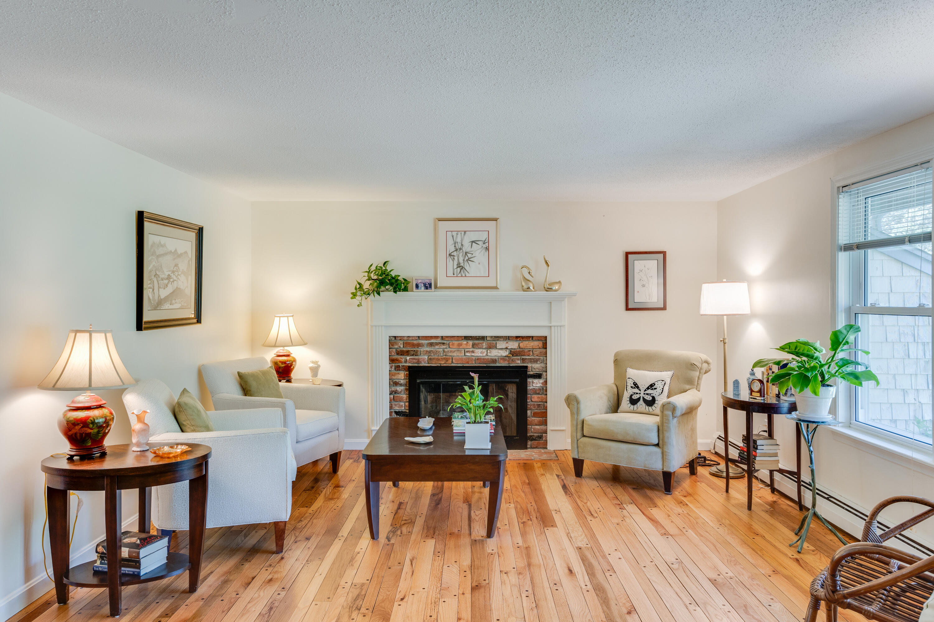 240 Braggs Lane Barnstable, MA 02630 - Photo 4 of 54 a living room with furniture and a fireplace