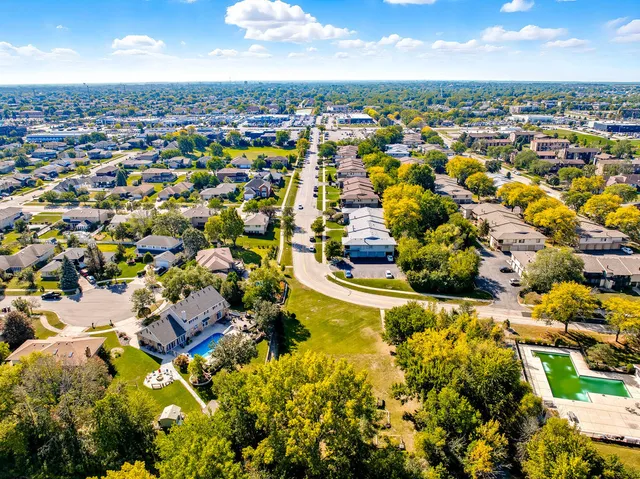 an aerial view of residential houses with outdoor space