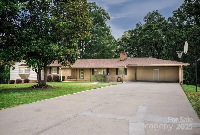 a front view of a house with a yard and trees