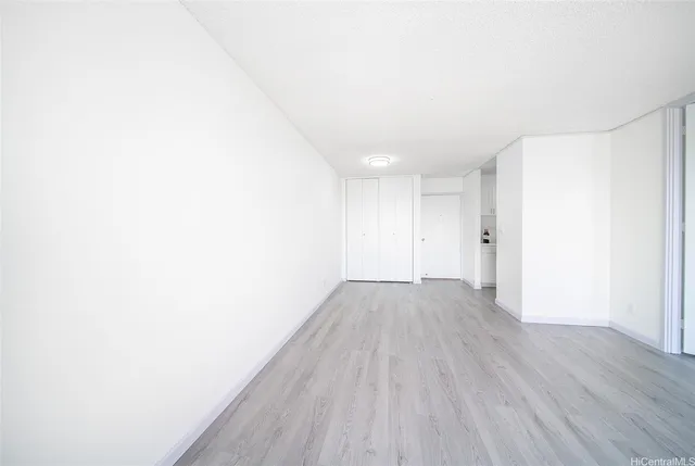a view of a room with wooden floor