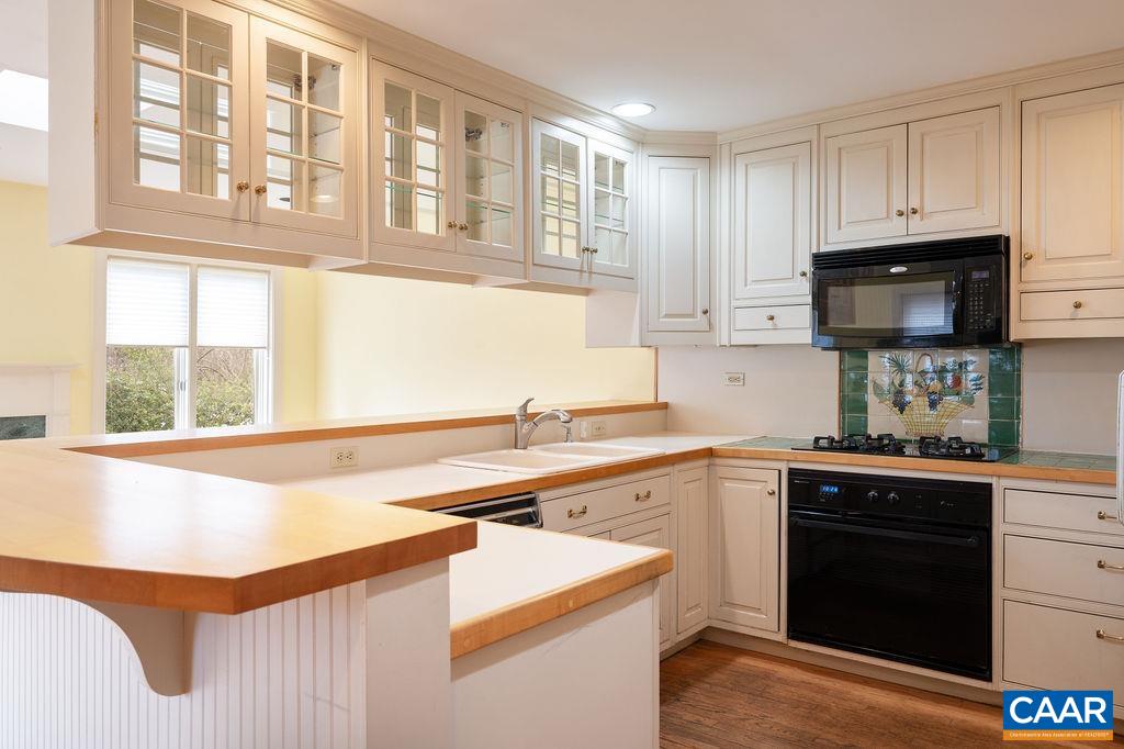 1334 Rugby Road Charlottesville, VA 22903 - Photo 8 of 36 a kitchen with stainless steel appliances granite countertop a sink and a stove