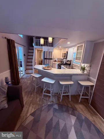 a room with furniture a rug and a flat screen tv