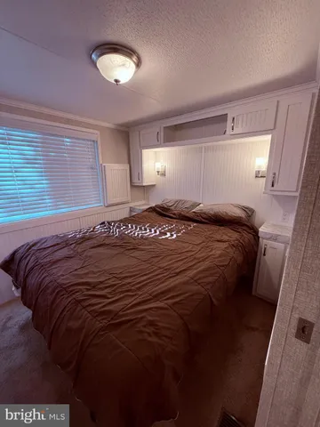 a bedroom with a bed and a lamp