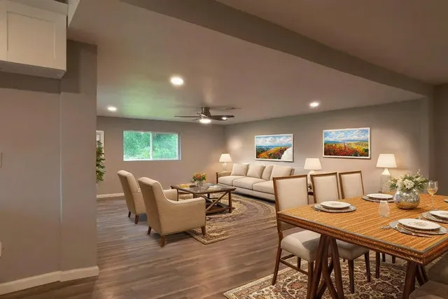 a living room with furniture a window and a table