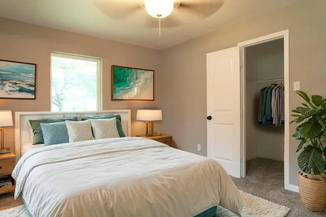 a bedroom with a bed and a window