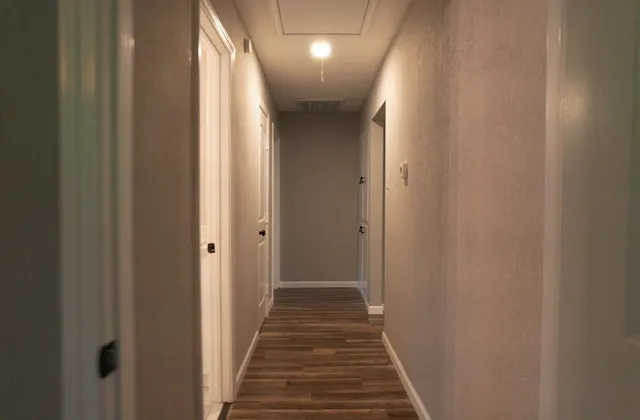 an empty room with chandelier fan