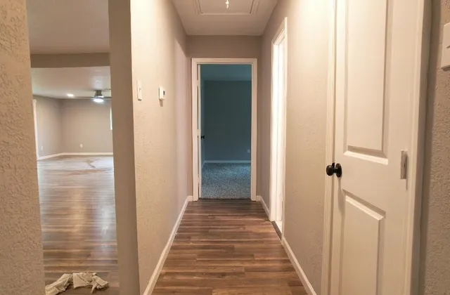 a bathroom with a granite countertop sink and cabinets