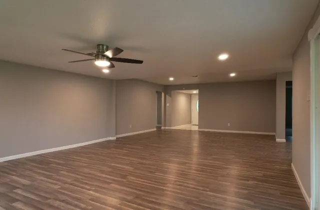 a view of an empty room with wooden floor