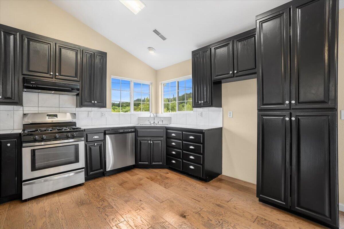 1196 Freshwater Road Eureka, CA 95503 - Photo 13 of 34 a kitchen with stainless steel appliances granite countertop a refrigerator stove and cabinets