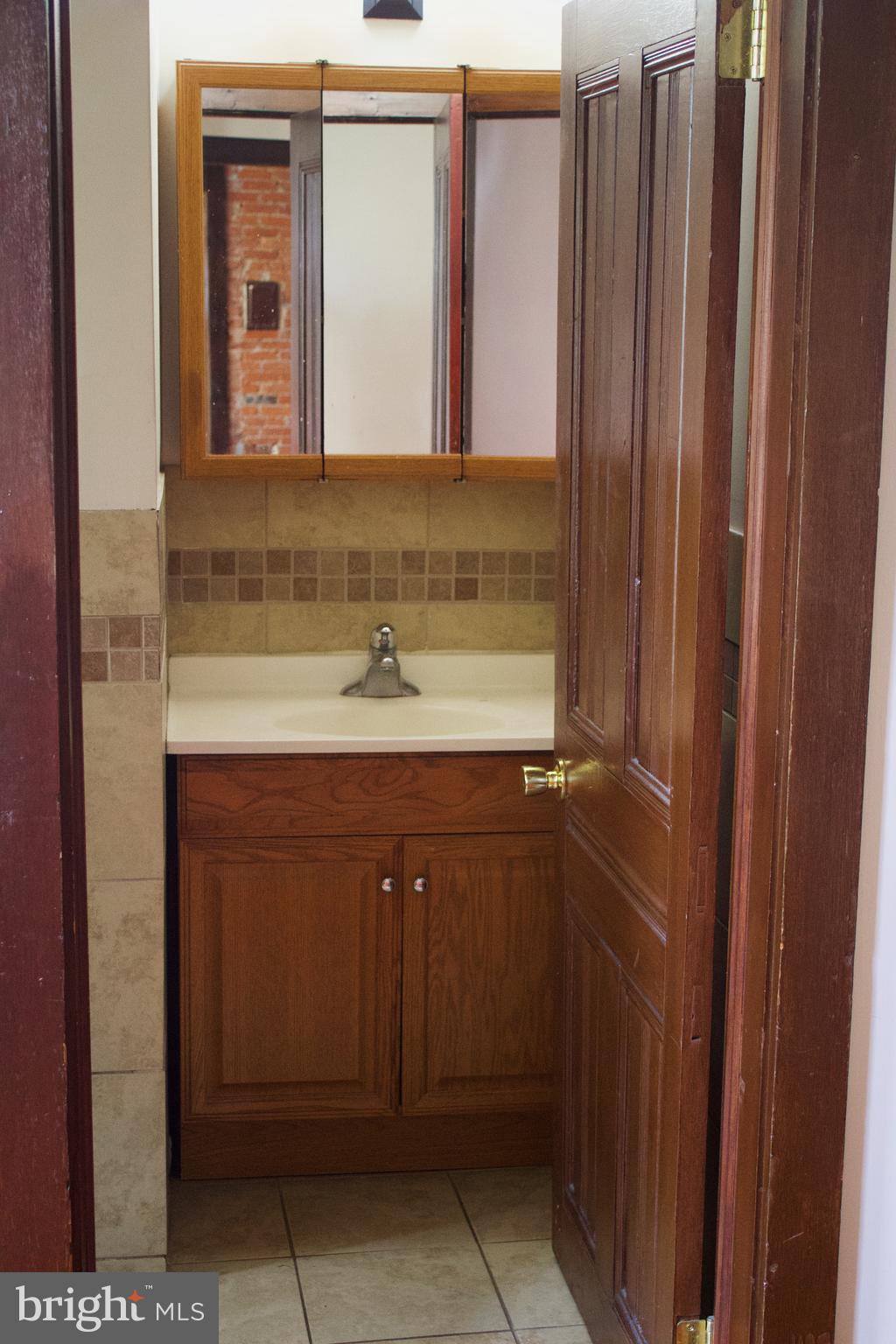 209 West Chestnut Street, Unit 2 West Chester, PA 19380 - Photo 15 of 23 a bathroom with a sink and a mirror