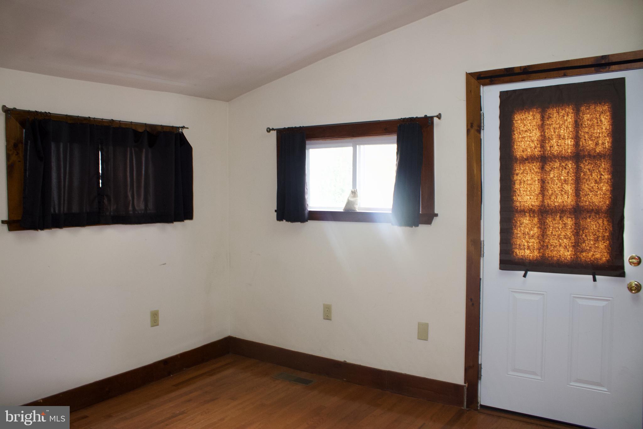 209 West Chestnut Street, Unit 2 West Chester, PA 19380 - Photo 19 of 23 an empty room with wooden floor and windows