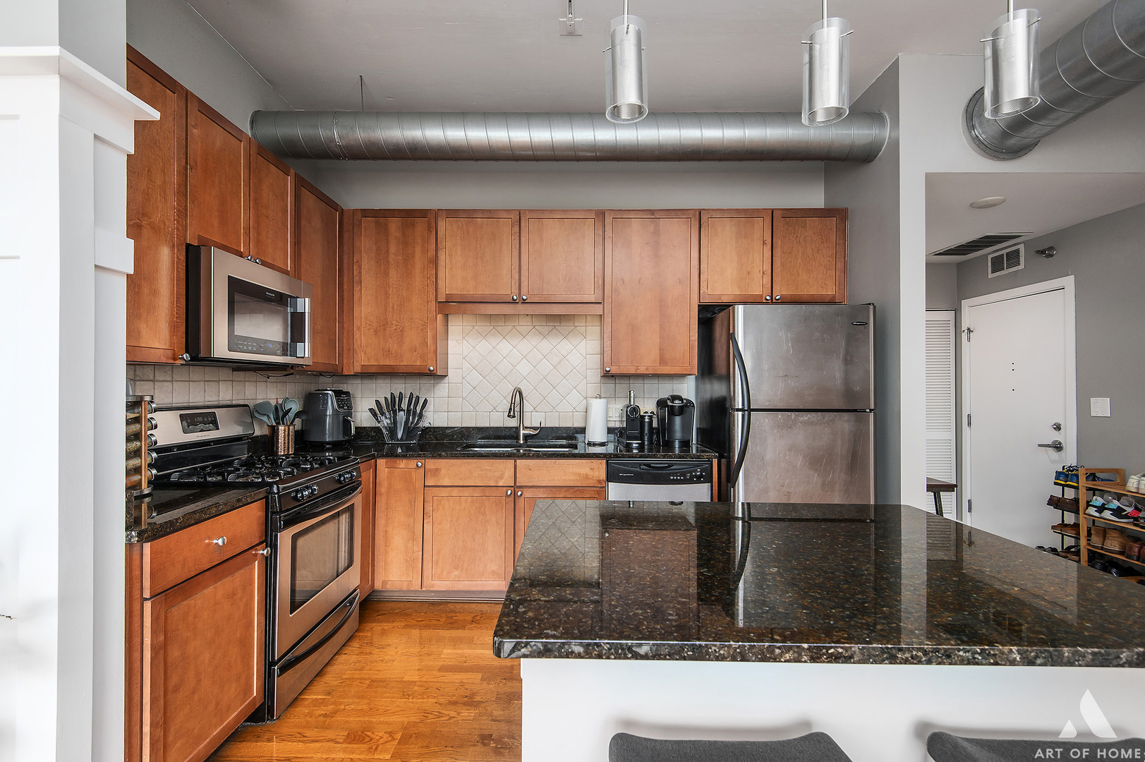 901 West Madison Street, Unit 407 Chicago, IL 60607 - Photo 15 of 39 a kitchen with granite countertop a refrigerator a stove and a sink